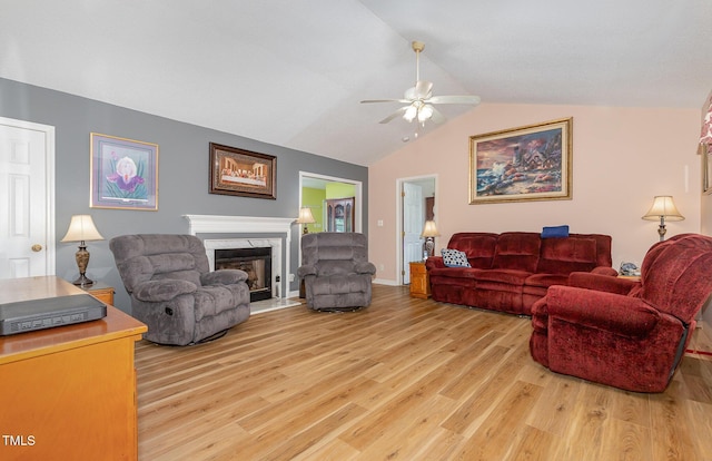 6408 Glen Brack Ct, Raleigh, NC 27603 - living room featuring light wood-type flooring, a ceiling fan, lofted ceiling, and a fireplace