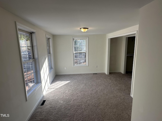 8505 Ray Rd, Raleigh, NC 27613 - unfurnished bedroom with multiple windows and carpet floors
