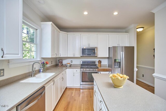 5328 Willow Cry Ln, Raleigh, NC 27613 - kitchen with appliances with stainless steel finishes, crown molding, white cabinets, light countertops, and recessed lighting