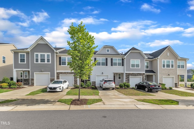 6549 Tremolo Trl, Raleigh, NC 27616 - townhome / multi-family property with stone siding, an attached garage, and driveway