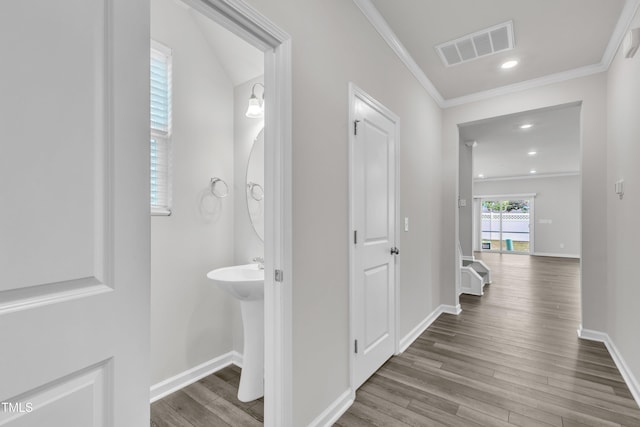 6549 Tremolo Trl, Raleigh, NC 27616 - hallway with wood finished floors, ornamental molding, and recessed lighting