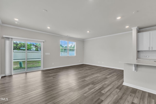 6549 Tremolo Trl, Raleigh, NC 27616 - unfurnished living room with ornamental molding, dark wood-type flooring, and recessed lighting
