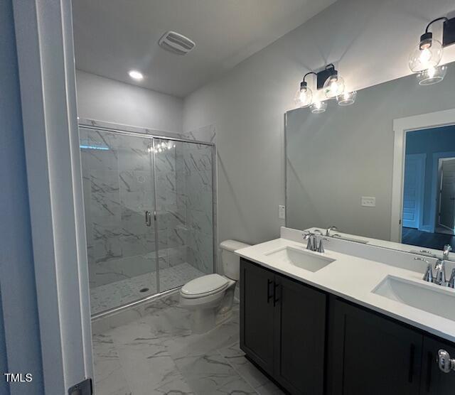 502 Yeowell Dr, Chapel Hill, NC 27514 - full bath featuring a marble finish shower, double vanity, and marble look tile flooring
