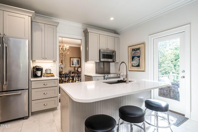 815 Marlowe Rd Unit 10, Raleigh, NC 27609 - kitchen featuring appliances with stainless steel finishes, gray cabinetry, ornamental molding, a chandelier, and light countertops