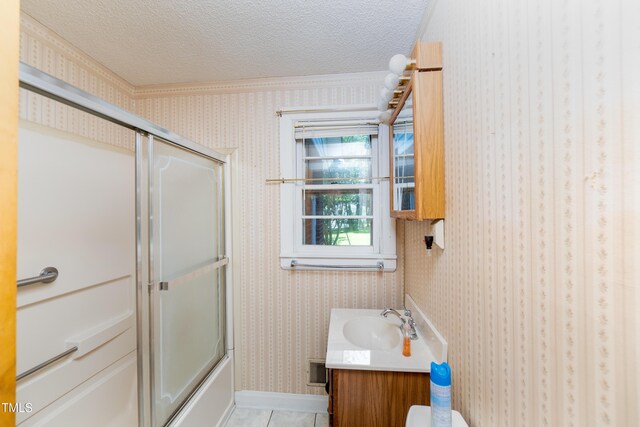 452 N Main St, Wendell, NC 27591 - full bathroom featuring vanity, tile patterned flooring, a textured ceiling, shower / bath combination with glass door, and wallpapered walls