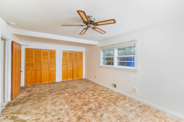 452 N Main St, Wendell, NC 27591 - unfurnished bedroom with a textured ceiling, two closets, carpet floors, and ceiling fan