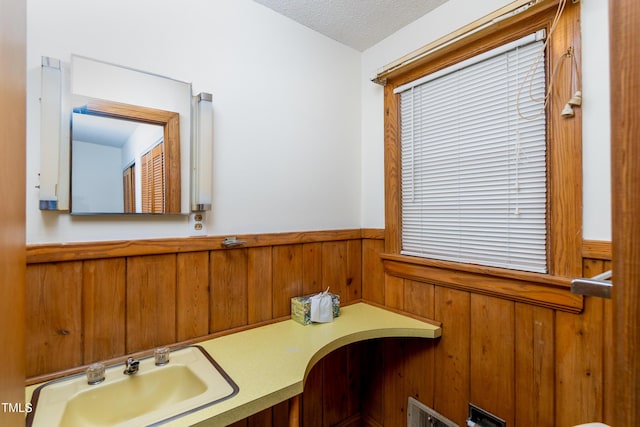 452 N Main St, Wendell, NC 27591 - bathroom featuring a wainscoted wall, wood walls, a textured ceiling, and vanity