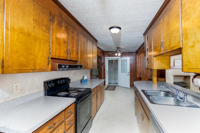 452 N Main St, Wendell, NC 27591 - kitchen with black electric range, wall chimney range hood, light countertops, ceiling fan, and brown cabinets