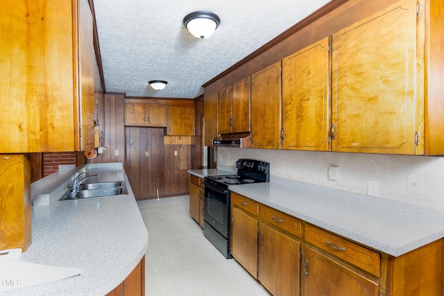 452 N Main St, Wendell, NC 27591 - kitchen featuring electric range, brown cabinets, light countertops, and wooden walls