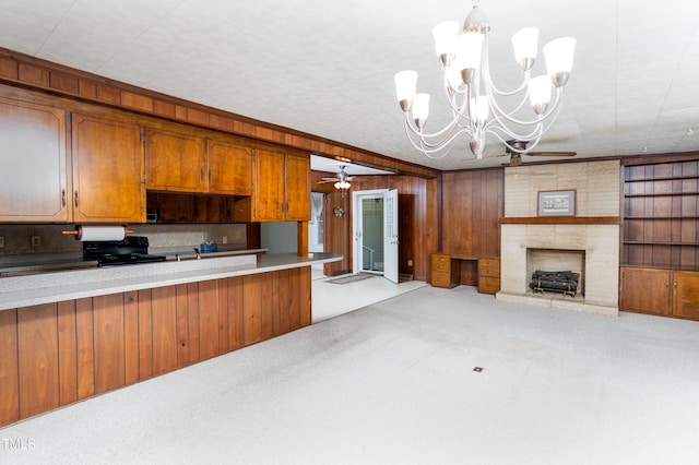 452 N Main St, Wendell, NC 27591 - kitchen featuring brown cabinetry, a chandelier, open floor plan, black range with electric stovetop, and light colored carpet