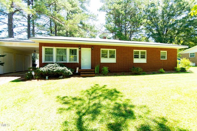 452 N Main St, Wendell, NC 27591 - ranch-style home featuring entry steps, a front lawn, an attached carport, and brick siding