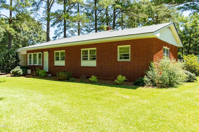 452 N Main St, Wendell, NC 27591 - view of front facade with a chimney, a front yard, and brick siding