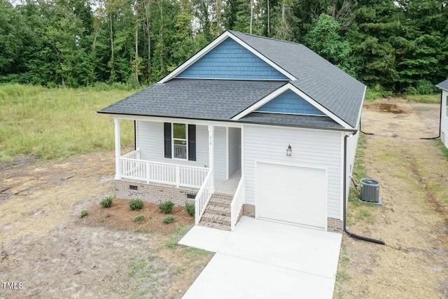 510 Branch St, Rocky Mount, NC 27801 - view of front of home featuring covered porch, a garage, roof with shingles, concrete driveway, and a view of trees