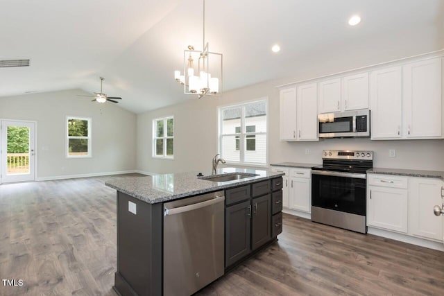 510 Branch St, Rocky Mount, NC 27801 - kitchen featuring stainless steel appliances, vaulted ceiling, white cabinetry, wood finished floors, and ceiling fan