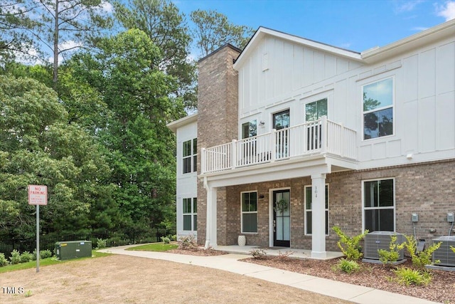 11548 Helmond Way # 104, Raleigh, NC 27617 - view of front of property with a balcony, board and batten siding, and brick siding