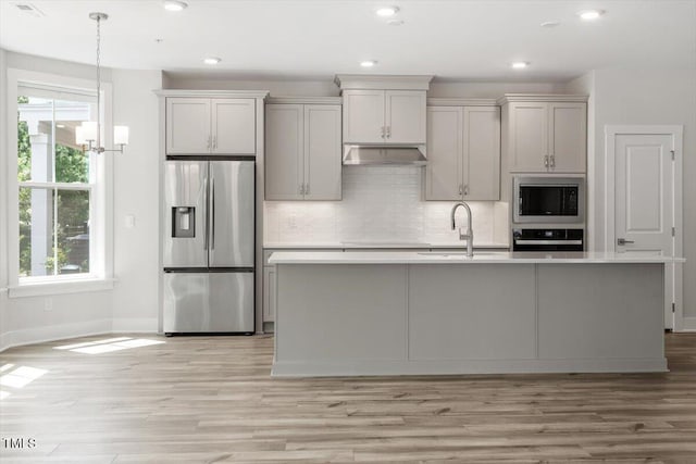 11548 Helmond Way # 104, Raleigh, NC 27617 - kitchen with stainless steel fridge, built in microwave, black oven, under cabinet range hood, and light countertops