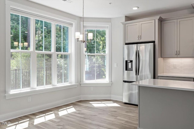 11548 Helmond Way # 104, Raleigh, NC 27617 - kitchen featuring stainless steel fridge, gray cabinets, healthy amount of natural light, backsplash, and recessed lighting
