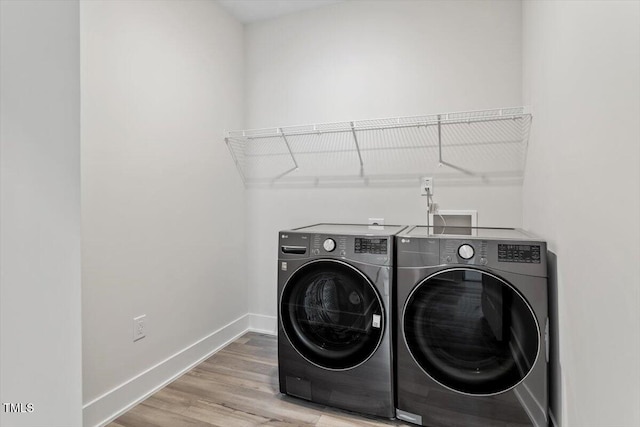11548 Helmond Way # 104, Raleigh, NC 27617 - washroom featuring washer and clothes dryer and light wood-style floors