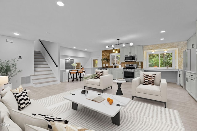 4812 Latimer Rd, Raleigh, NC 27609 - living area with stairway, light wood-style flooring, and recessed lighting