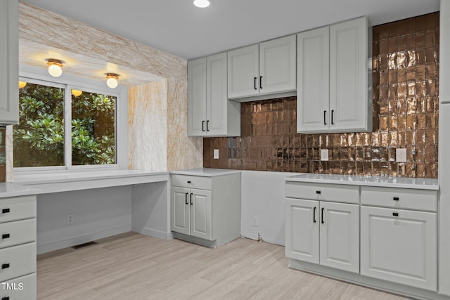 4812 Latimer Rd, Raleigh, NC 27609 - kitchen with backsplash, light countertops, light wood finished floors, built in desk, and recessed lighting