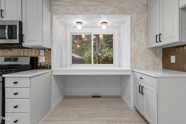 4812 Latimer Rd, Raleigh, NC 27609 - kitchen with stainless steel appliances, backsplash, and white cabinetry