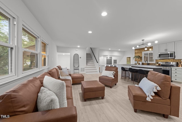 4812 Latimer Rd, Raleigh, NC 27609 - living room featuring stairs, recessed lighting, and light wood-type flooring