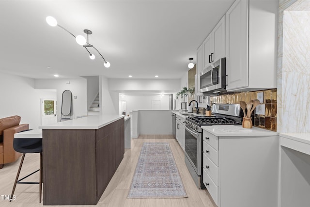 4812 Latimer Rd, Raleigh, NC 27609 - kitchen featuring stainless steel appliances, open floor plan, light countertops, a center island, and white cabinets