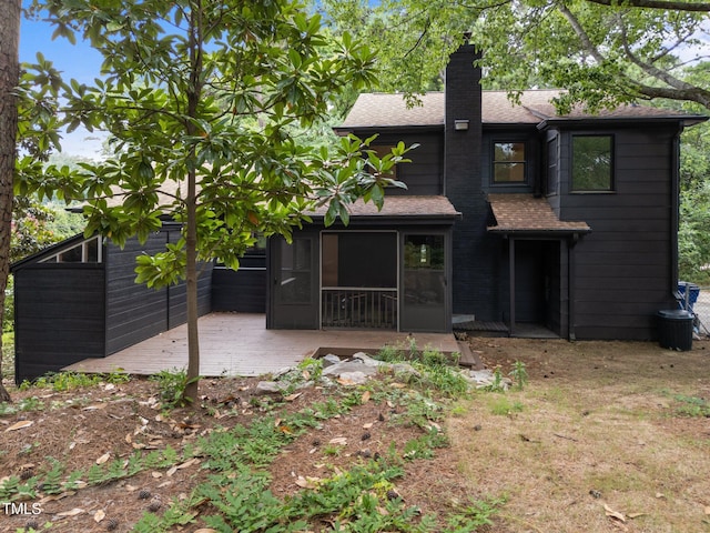 4812 Latimer Rd, Raleigh, NC 27609 - back of house with a chimney, a sunroom, roof with shingles, and a deck