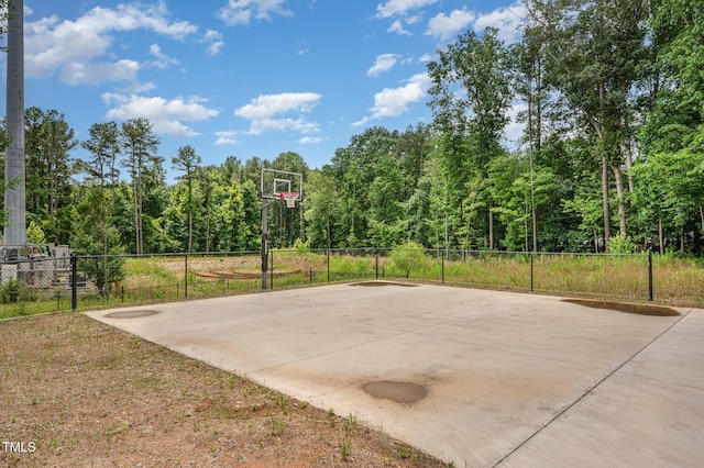 1106 Nova St, Durham, NC 27713 - view of sport court featuring basketball hoop and a forest view