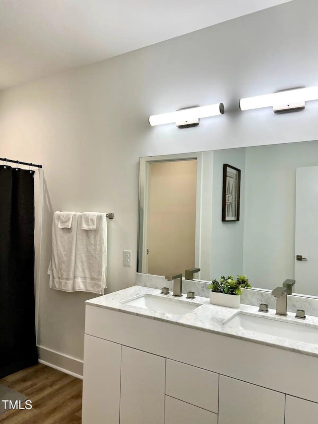 1106 Nova St, Durham, NC 27713 - bathroom featuring wood finished floors and double vanity
