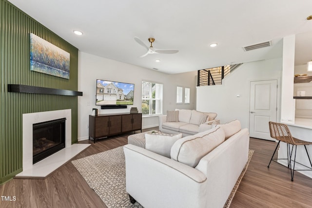 3194 Retama Run, New Hill, NC 27562 - living area featuring ceiling fan, wood finished floors, a glass covered fireplace, and recessed lighting