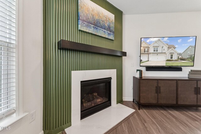 3194 Retama Run, New Hill, NC 27562 - unfurnished living room with wood finished floors and a glass covered fireplace