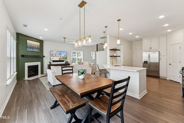3194 Retama Run, New Hill, NC 27562 - dining area with wood finished floors, recessed lighting, and a large fireplace
