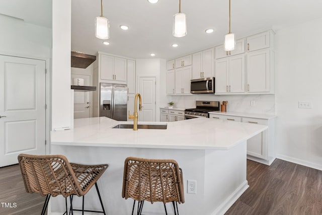 3194 Retama Run, New Hill, NC 27562 - kitchen with appliances with stainless steel finishes, a peninsula, dark wood-style flooring, a breakfast bar, and white cabinetry