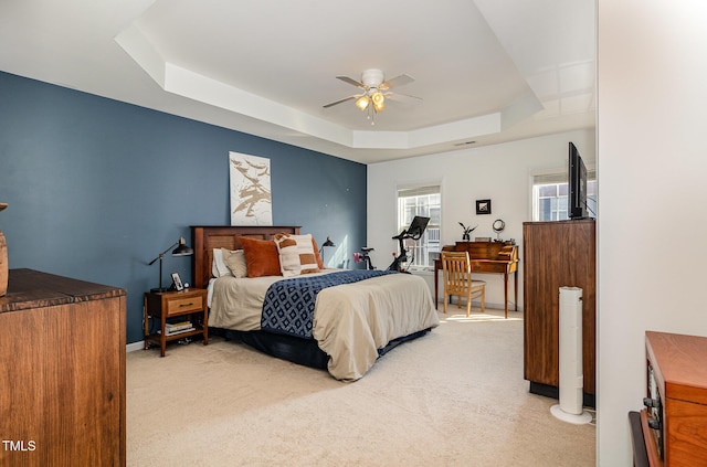 513 Dragby Ln, Raleigh, NC 27603 - bedroom with light colored carpet, a raised ceiling, and ceiling fan