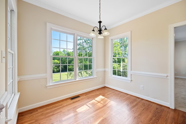 306 Neuse Ridge Dr, Clayton, NC 27527 - unfurnished dining area featuring a chandelier, ornamental molding, and wood finished floors