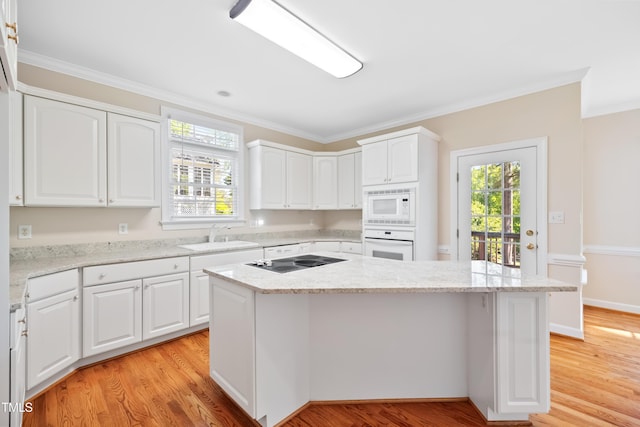 306 Neuse Ridge Dr, Clayton, NC 27527 - kitchen with white appliances, crown molding, light wood-type flooring, a center island, and white cabinetry
