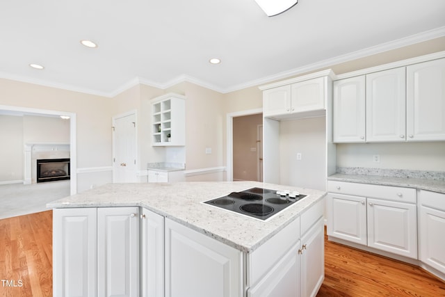 306 Neuse Ridge Dr, Clayton, NC 27527 - kitchen featuring electric stovetop, a kitchen island, crown molding, light stone counters, and white cabinetry