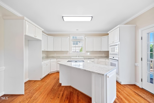 306 Neuse Ridge Dr, Clayton, NC 27527 - kitchen with white appliances, light wood-style flooring, white cabinetry, a kitchen island, and crown molding