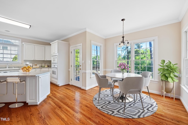 306 Neuse Ridge Dr, Clayton, NC 27527 - dining space with light wood-type flooring, healthy amount of natural light, and crown molding