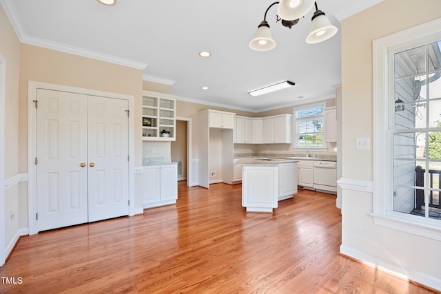 306 Neuse Ridge Dr, Clayton, NC 27527 - kitchen with white dishwasher, crown molding, white cabinetry, light countertops, and light wood-style floors