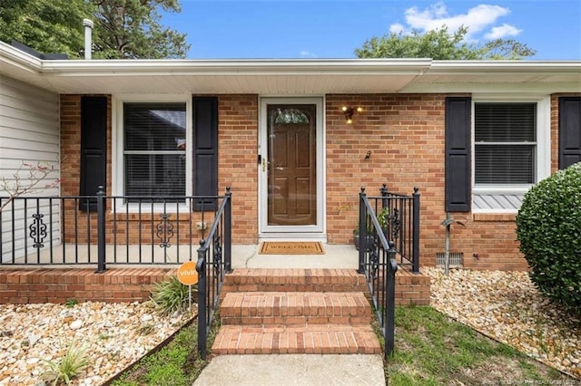 325 Hamilton St, Fayetteville, NC 28301 - doorway to property with covered porch and brick siding