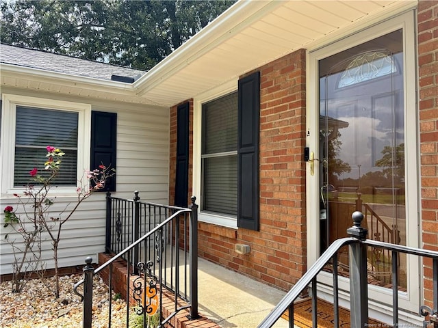 325 Hamilton St, Fayetteville, NC 28301 - property entrance featuring a shingled roof and brick siding