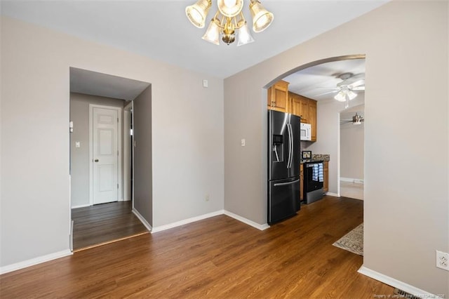 325 Hamilton St, Fayetteville, NC 28301 - kitchen with stainless steel appliances, arched walkways, a chandelier, and wood finished floors