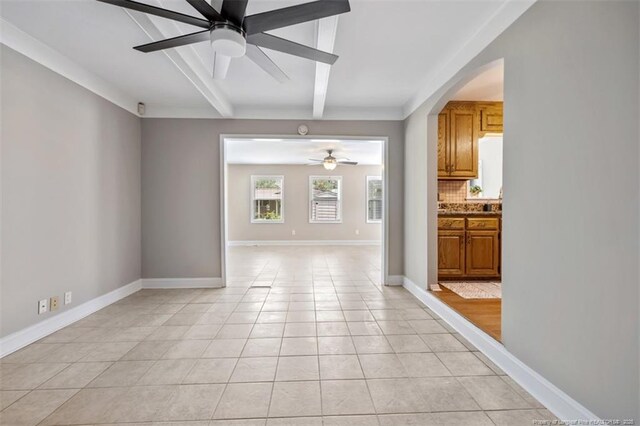 325 Hamilton St, Fayetteville, NC 28301 - empty room featuring a ceiling fan, light tile patterned floors, beamed ceiling, and arched walkways