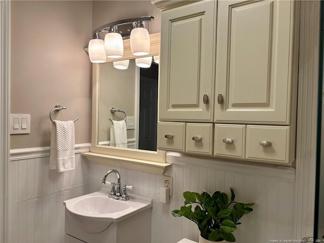 325 Hamilton St, Fayetteville, NC 28301 - bathroom featuring a wainscoted wall, vanity, and a decorative wall