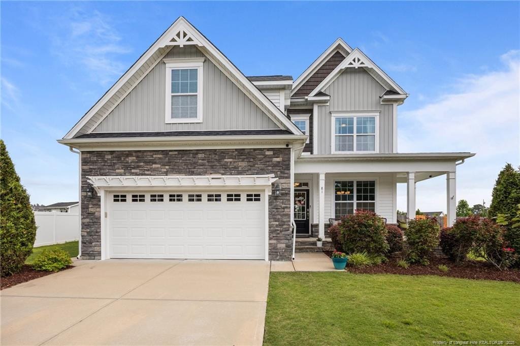 81 Dot Ct, Fuquay Varina, NC 27526 - craftsman-style home with stone siding, board and batten siding, driveway, covered porch, and a garage