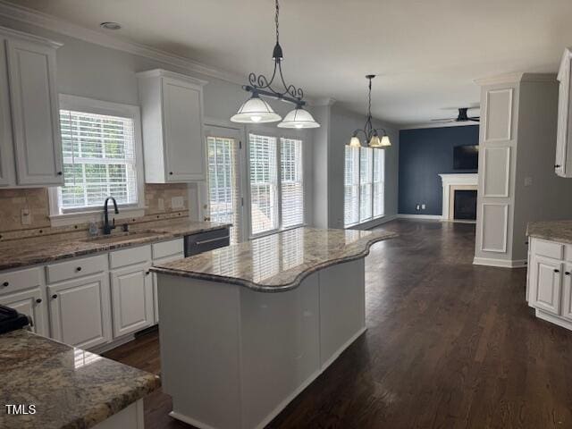 114 Council Gap Ct, Cary, NC 27513 - kitchen with white cabinets, crown molding, dark wood-style floors, ceiling fan, and tasteful backsplash