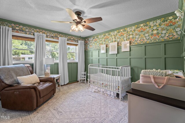 12082 NC-42, Fuquay Varina, NC 27526 - bedroom featuring wallpapered walls, ornamental molding, a nursery area, a decorative wall, and a textured ceiling