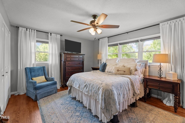 12082 NC-42, Fuquay Varina, NC 27526 - bedroom featuring wood finished floors, a textured ceiling, and a ceiling fan